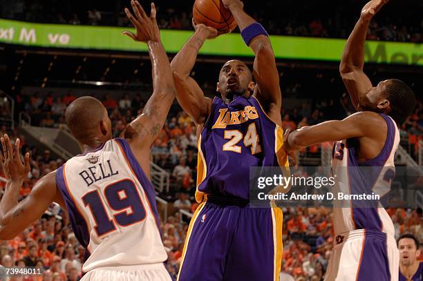 Kobe Bryan of the Los Angeles Lakers shoots through the double team of Raja Bell and James Jones of the Phoenix Suns in Game One of the Western...