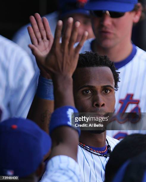 Jose Reyes of the New York Mets celebrates with teammates after hitting a three run triple against the Atlanta Braves during their game at Shea...