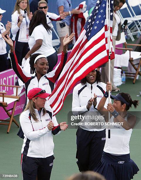 Delray Beach, UNITED STATES: Vania King of theUS carries the US flag as she celebrates with teammates Serena Williams , Venus Williams and Lisa...