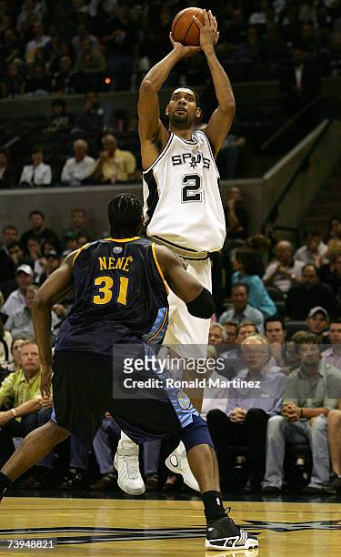 Forward Tim Duncan of the San Antonio Spurs takes a shot against Nene of the Denver Nuggets in Game One of the Western Conference Quarterfinals...