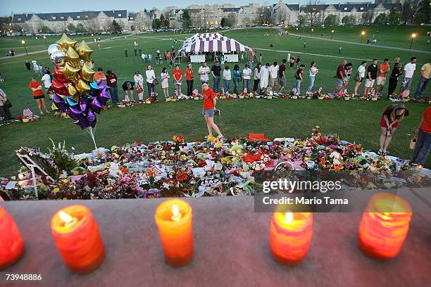 Mourners gather at a makeshift memorial for the 32 shooting victims on the Virginia Tech campus April 22, 2007 in Blacksburg, Virginia. Students will...