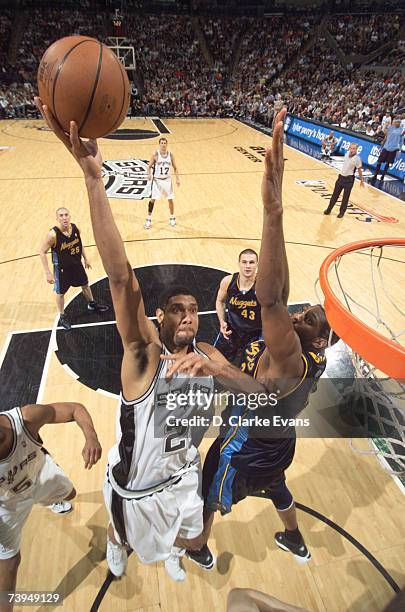 Tim Duncan of the San Antonio Spurs shoots against Nene of the Denver Nuggets in Game One of the Western Conference Quarterfinals during the 2007 NBA...