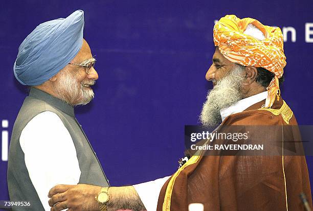 Pakistan National Assembly Opposition Leader Maulana Fazalur Rehman embraces Indian Prime Minister Manmohan Singh at a Fida-e-millat Seminar...