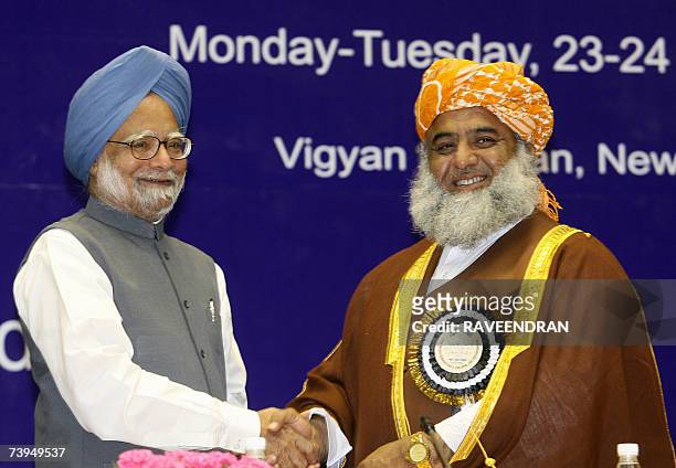 Pakistan National Assembly Opposition Leader Maulana Fazalur Rehman shakes hands with Indian Prime Minister Manmohan Singh at a Fida-e-millat Seminar...