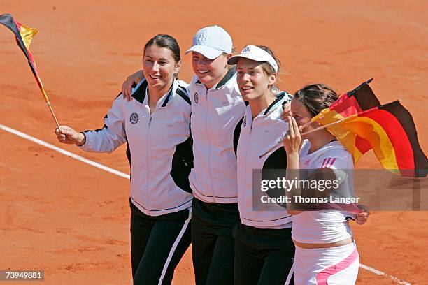 Sandra Kloesels, Anna-Lena Groenefeld, Andrea Petkovic and Tatjana Malek of Germany celebrate after Malek?s game against Ivana Lisjak during the Fed...
