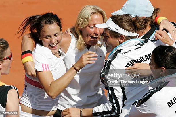 Tatjana Malek, team captain Barbara Rittner and Andrea Petkovic of Germany celebrate after Malek?s game against Ivana Lisjak during the Fed Cup game...