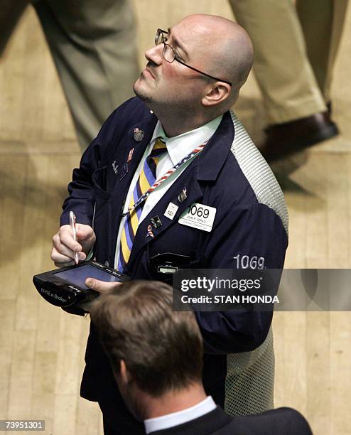 New York, UNITED STATES: A trader watches a moitor on the floor of the New York Stock Exchange, 23 April 2007. The Dow Jones Industrial Average...