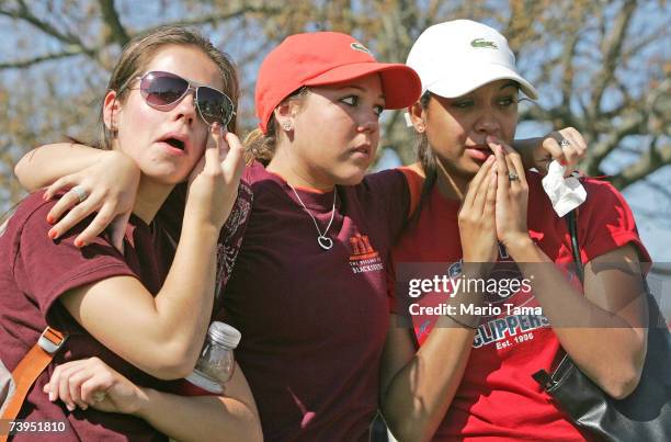 Virginia Tech students grieve following a moment of silence at a makeshift memorial to the shooting victims April 23, 2007 in Blacksburg, Virginia....