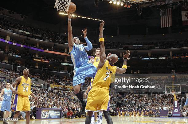 Carmelo Anthony of the Denver Nuggets lays the ball past Luke Walton and Lamar Odom of the Los Angeles Lakers at Staples Center on April 3, 2007 in...