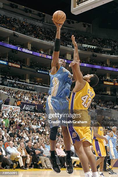 Nene of the Denver Nuggets hooks a shot over Brian Cook of the Los Angeles Lakers at Staples Center on April 3, 2007 in Los Angeles, California. The...
