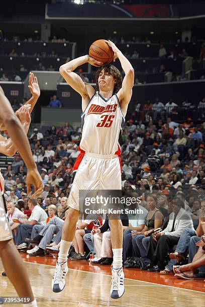 Adam Morrison of the Charlotte Bobcats takes a jump shot against the New Jersey Nets at Charlotte Bobcats Arena on March 24, 2007 in Charlotte, North...