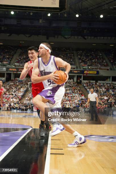 Brad Miller of the Sacramento Kings drives around Yao Ming of the Houston Rockets at Arco Arena on April 8, 2007 in Sacramento, California. The...