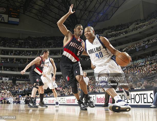 Devean George of the Dallas Mavericks drives against Ime Udoka of the Portland Trailblazers during the game at American Airlines Center on April 7,...