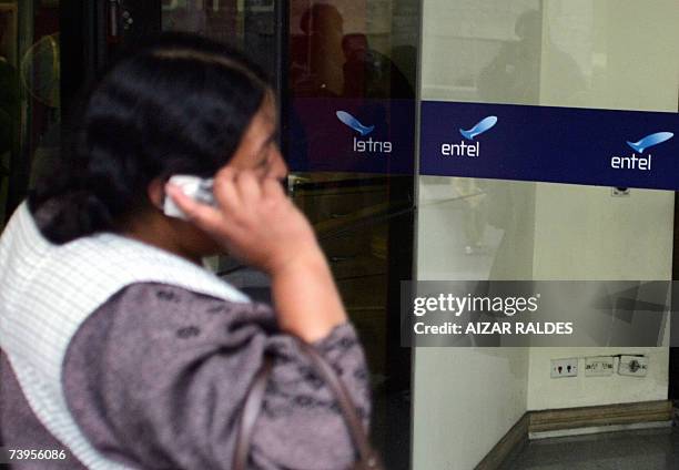 Bolivian Aymara woman speaks by mobile near an Entel office 23 April, 2007 in La Paz. The Bolivian government on Monday ordered two private pension...