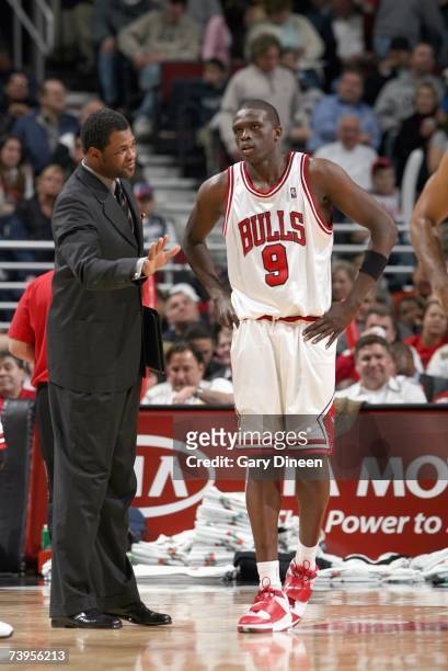 Assistant coach Pete Meyers stands with Luol Deng of the Chicago Bulls during the NBA game against the Charlotte Bobcats at United Center on April...