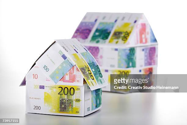 two houses of euro notes, close-up - two hundred euro banknote stock pictures, royalty-free photos & images