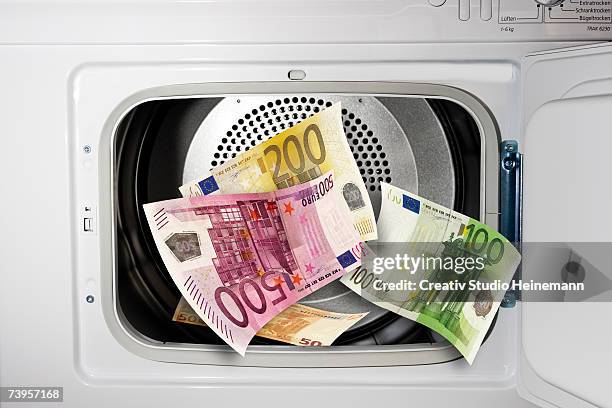 euro notes in washing machine, close-up - money laundery stockfoto's en -beelden