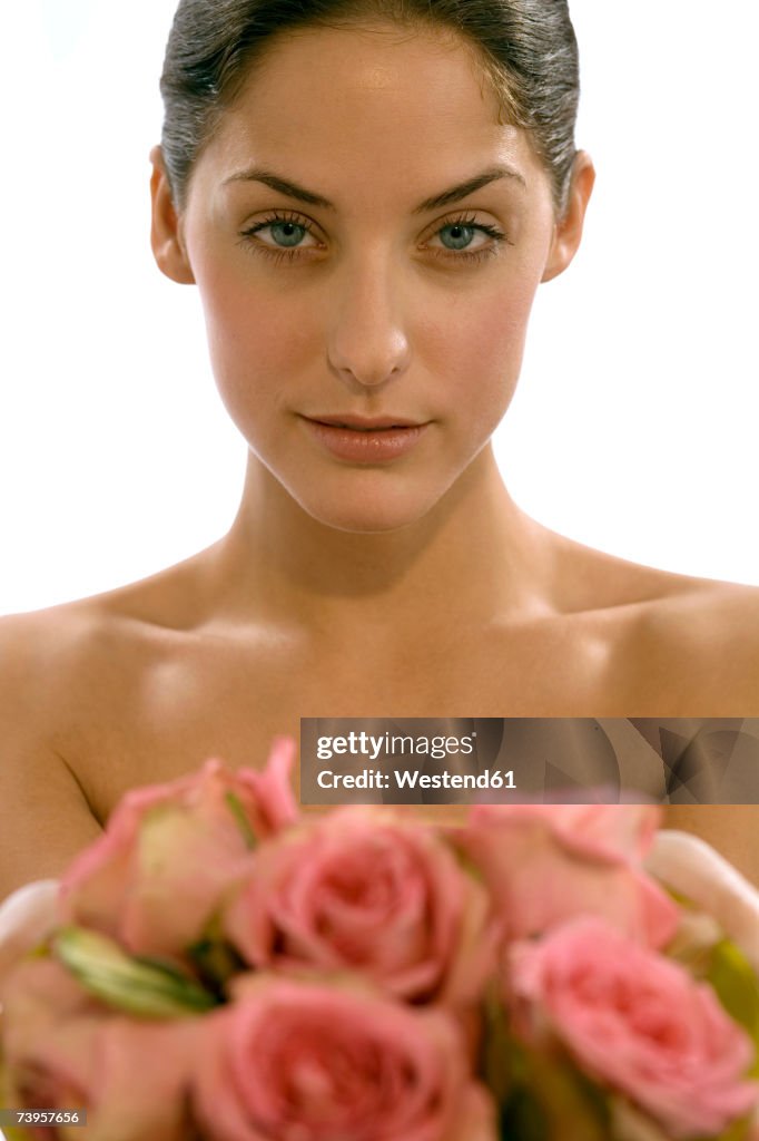 Young woman holding rose flowers, portait