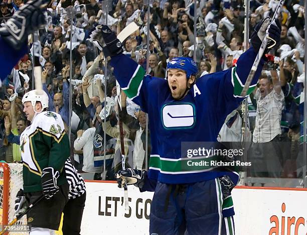 Trevor Linden of the Vancouver Canucks celebrates his game winning goal as Jon Klemm of the Dallas Stars stands dejected during game seven of the...