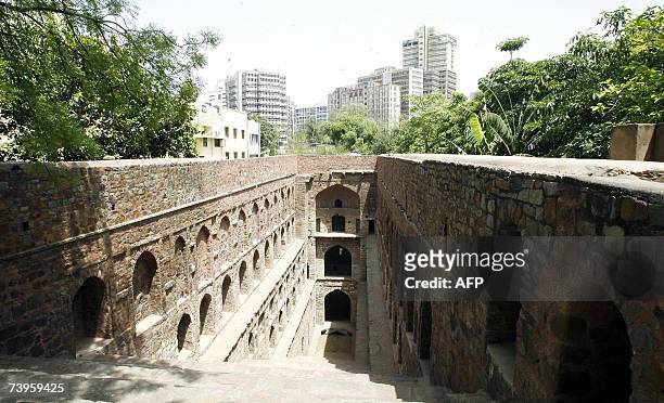 The skyscrapers of the central district are seen in the background behind the Ugrasen-Ki-Baoli step-well in New Delhi, 24 April 2007....