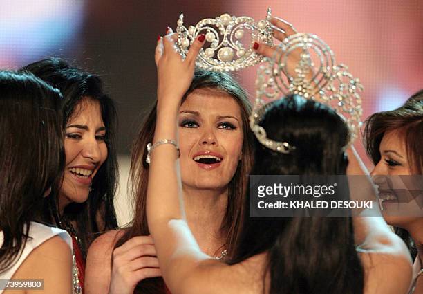 Ehsan Hatem is crowned by Miss Egypt 2007 by last year's winner Fawzaya Mohamed at the end of the beauty pageant late 23 April 2007 in Cairo. Twenty...