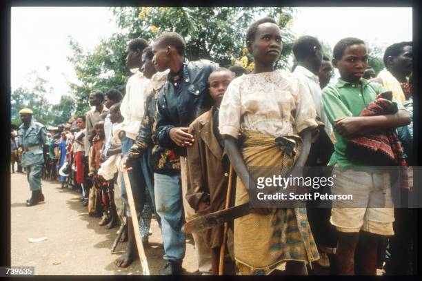 Armed civilians wait for Red Cross-delivered food April 13, 1994 in Kigali, Rwanda. Following the apparent assassination of Rwandan President Juvenal...