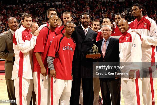 Toronto Raptors coach Sam Mitchell accepts the Red Auerbach Trophy for 2006-07 NBA Coach of the Year from NBA Commissioner David Stern before Game...