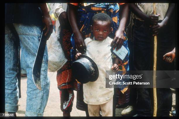 Armed civilians wait for Red Cross-delivered food April 13, 1994 in Kigali, Rwanda. Following the apparent assassination of Rwandan President Juvenal...