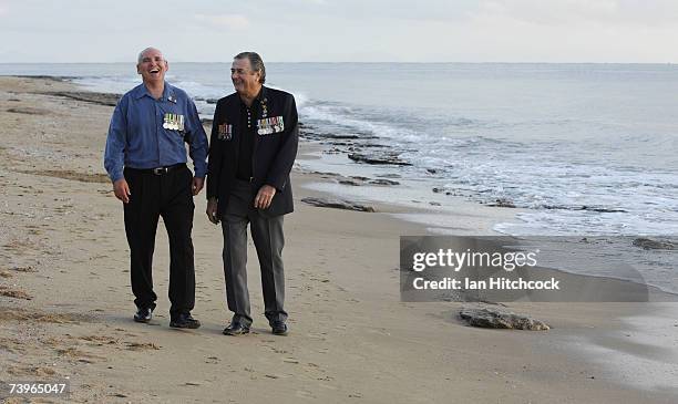 Veterans Mick Coulson and Laurie Roberts share a laugh during an ANZAC day commemorative dawn service at Balgal Beach April 25, 2007. Australians and...