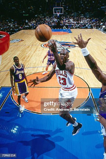 Michael Jordan of the Eastern Conference shoots against Eddie Jones of the Western Conference during the 1997 All-Star Game on February 9, 1997 at...