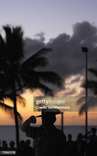 An Australian Army officer salutes during an ANZAC day commemorative dawn service at Balgal Beach April 25, 2007. Australians and New Zealanders...