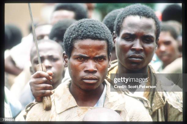 Armed Hutus wait outside a United Nations compound housing Tutsi people April 13, 1994 in Kigali, Rwanda. Following the apparent assassination of...