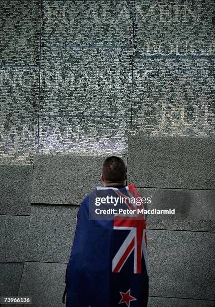 Man draped in a flag looks at the Australian War Memorial on April 25, 2007 in London. The yearly ANZAC memorial service remembers the soldiers of...