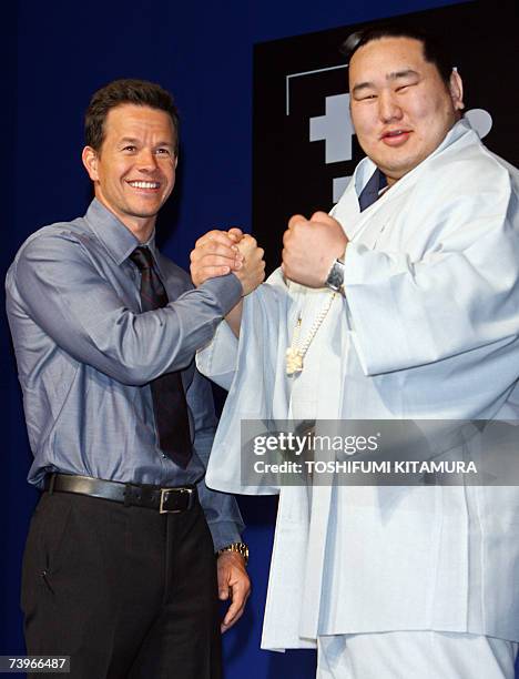 Hollywood star Mark Wahlberg poses in a photo session with Mongolian sumo wrestler Yokozuna, or grand champion Asashoryu during his latest movie,...