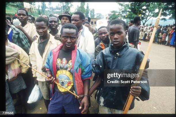 Armed civilians wait for Red Cross-delivered food April 13, 1994 in Kigali, Rwanda. Following the apparent assassination of Rwandan President Juvenal...