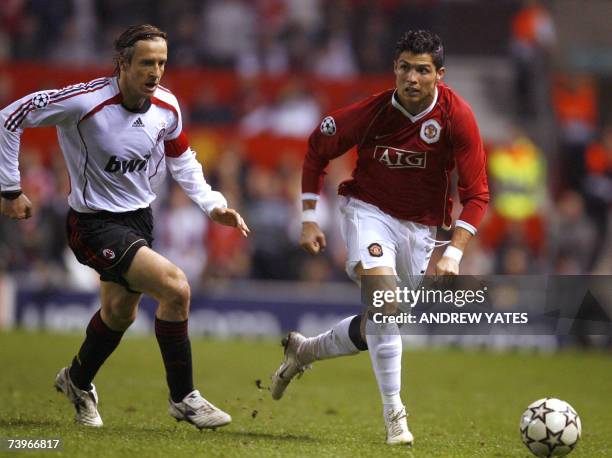 Manchester, UNITED KINGDOM: EDS NOTE: CORRECTING NAME OF PLAYER: Manchester United's Portugese midfielder Cristiano Ronaldo vies with AC Milan's...