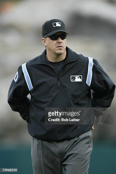 Umpire Paul Emmel stands on the field during the game between the Los Angeles Angels of Anaheim and the Oakland Athletics at Angel Stadium in...