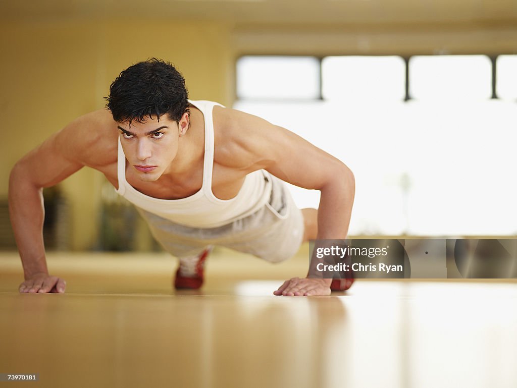 Man doing push-ups in a fitness studio