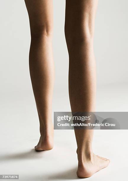 woman's bare legs, rear view - woman walking studio back stock pictures, royalty-free photos & images