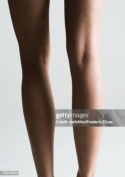 woman's bare legs, rear view - female legs studio shot stock pictures, royalty-free photos & images