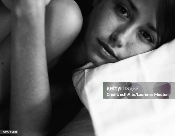 woman lying down, black and white - woman curled up stock pictures, royalty-free photos & images