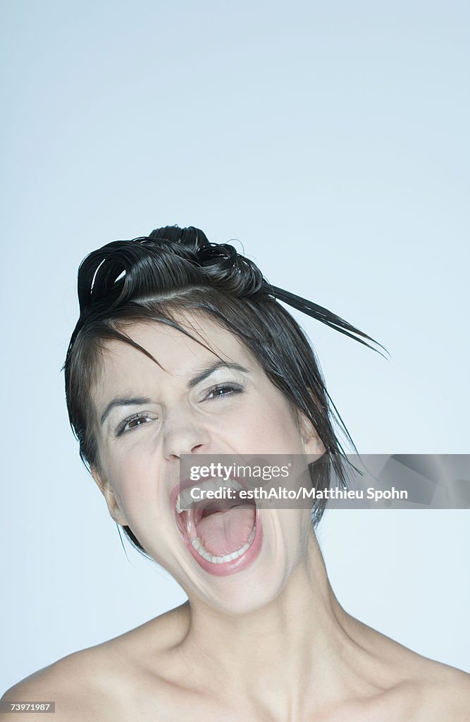 Woman with spiky hairstyle, mouth open, portrait