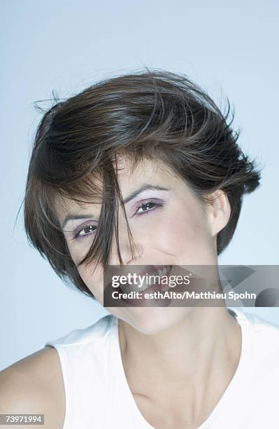 woman with short hair, strand of hair in front of face, smiling, portrait - before and after hair stock-fotos und bilder