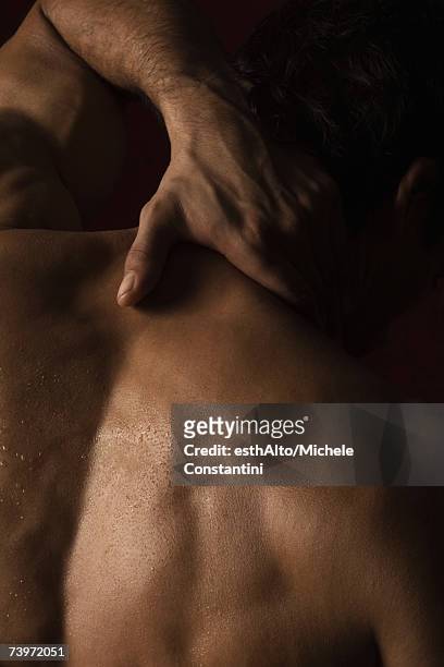 man with hand on back of neck - dark skin stock pictures, royalty-free photos & images