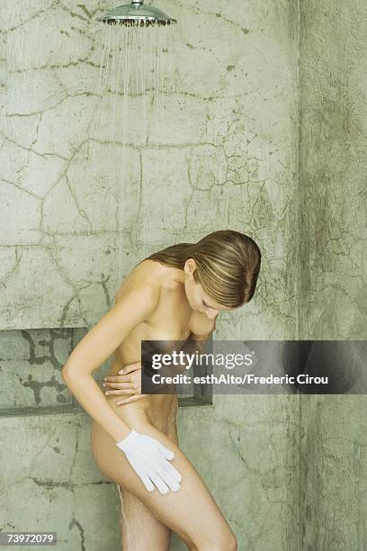 woman using massage glove in shower - skinny blonde pics stock pictures, royalty-free photos & images