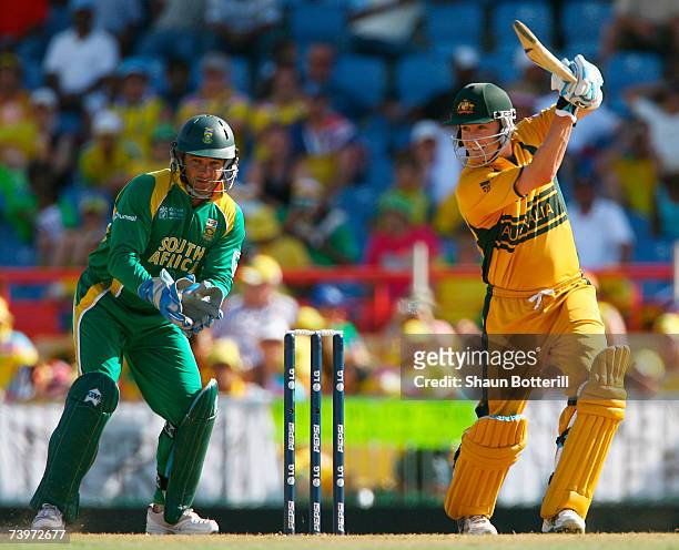 Michael Clarke of Australia hits out watched by Mark Boucher of South Africa during the ICC Cricket World Cup Semi Final match between Australia and...