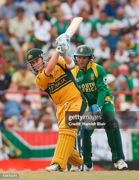 Michael Clarke of Australia hits out watched by Mark Boucher of South Africa during the ICC Cricket World Cup Semi Final match between Australia and...