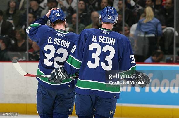 Daniel Sedin and Henrik Sedin of the Vancouver Canucks skate on the ice against the Dallas Stars during Game 7 of the 2007 Western Conference...