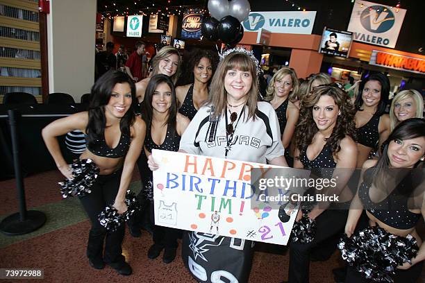 Spurs fan, who recognizes it's Tim Duncan's 31st birthday today, poses with the Silver Dancers before the San Antonio Spurs host the Denver Nuggets...