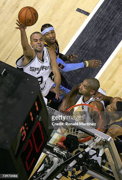 Guard Tony Parker of the San Antonio Spurs takes a shot against Allen Iverson of the Denver Nuggets in Game Two of the Western Conference...